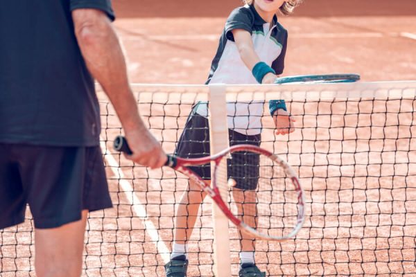 active-little-boy-practicing-tennis-with-crop-male-2022-02-03-23-30-10-utc.jpg