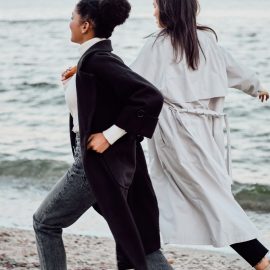 two-attractive-stylish-girls-in-trench-coats-happi-S8SUAFT.jpg