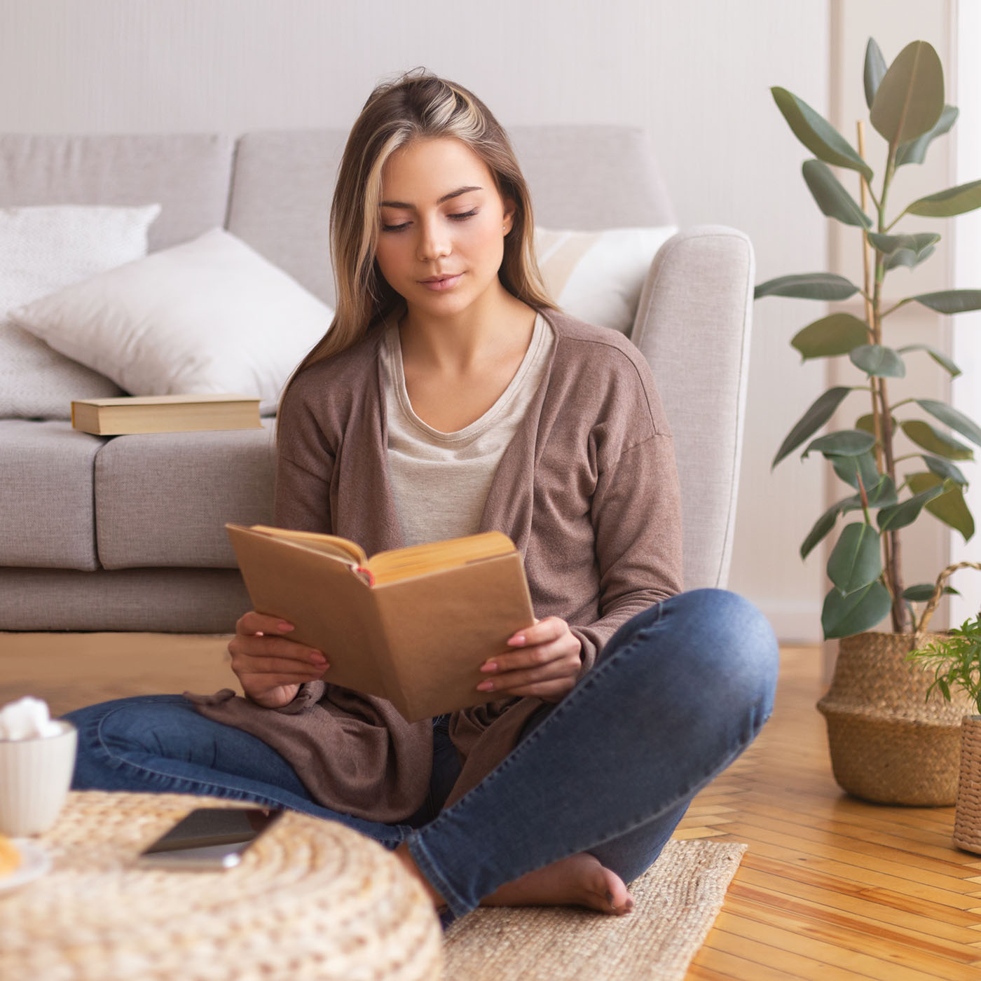 beautiful-young-woman-reading-book-on-floor-2022-12-16-09-23-59-utc.jpg